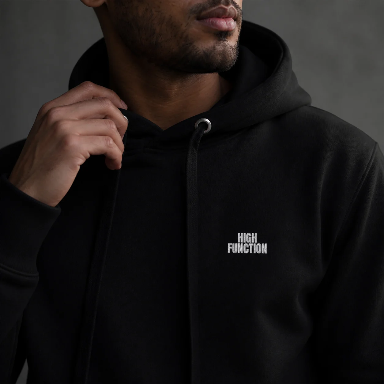 Close view of the High Function hoodie fabric, hood and embroidered chest mark