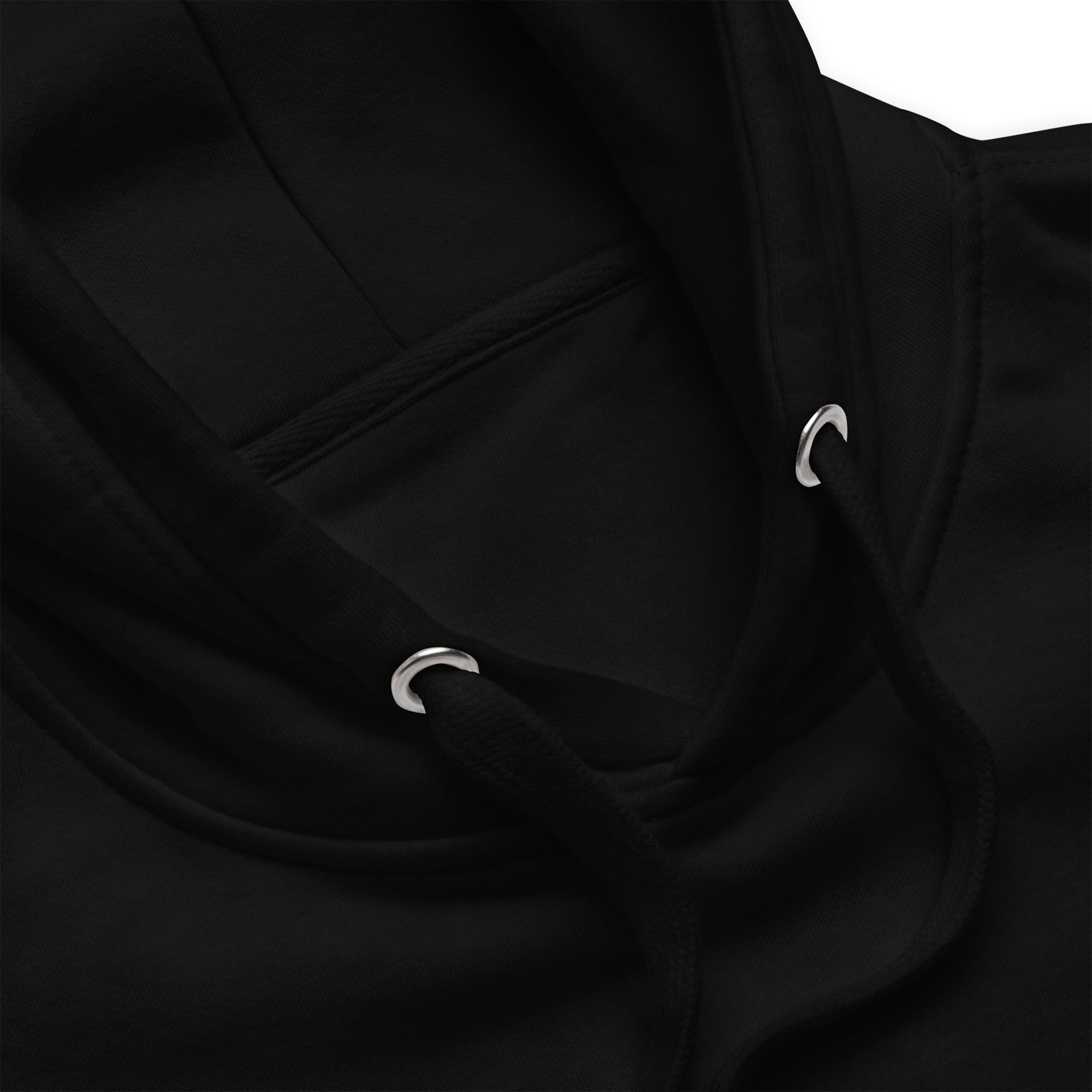 Macro detail of the Heavyweight Hoodie — lined hood, flat drawstrings and metal eyelets